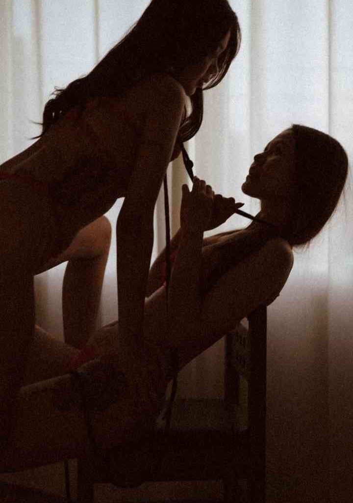 KL Escort Girl Two women in lingerie pose intimately by a window Malaysia Escort Sex in Kuala Lumpur